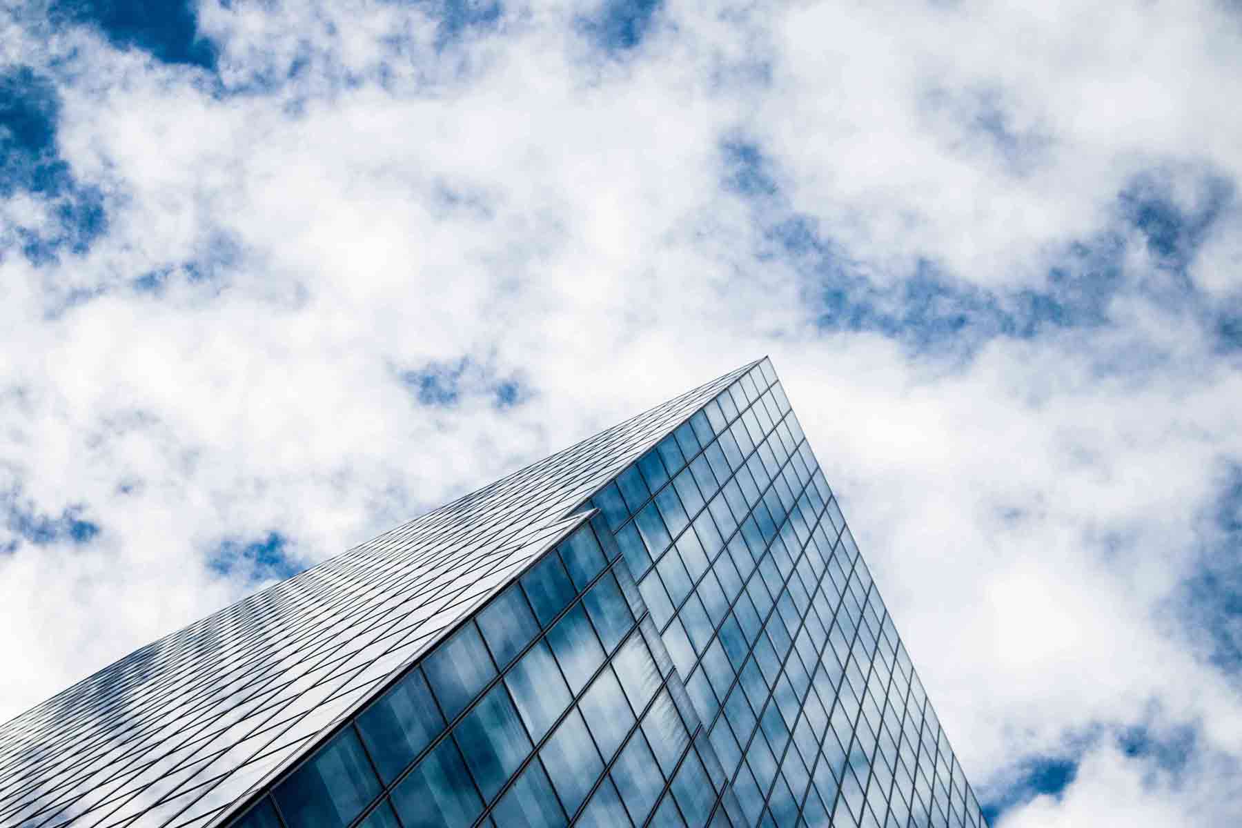 Exterior of an office building with a cloudy blue sky